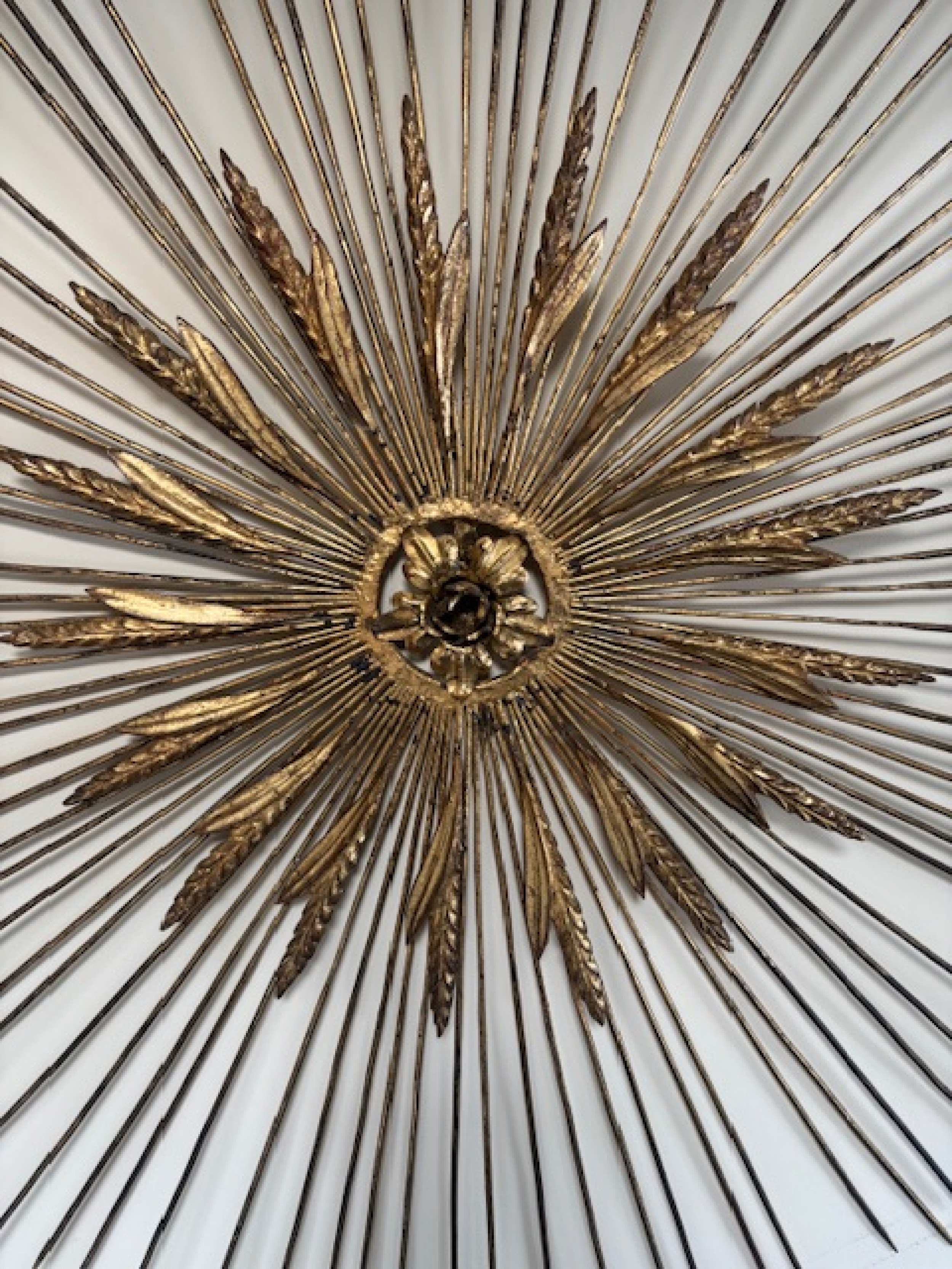 Mid centur gilt metal sunburst with wheat and spoke design